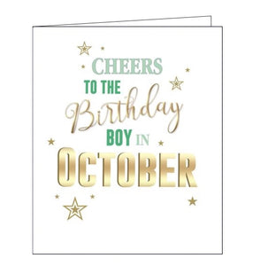 This birthday card is decorated with green and gold script that reads "Cheers to the Birthday boy in October". Embossed gold stars are sprinkled around the text.
