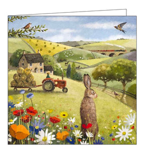 This blank greetings card features detail from an artwork by Roy Thompson showing a brown hare in the foreground, looking out over a busy scene of life in the countryside with a farmer in his tractor and fields full of sheep and horses.