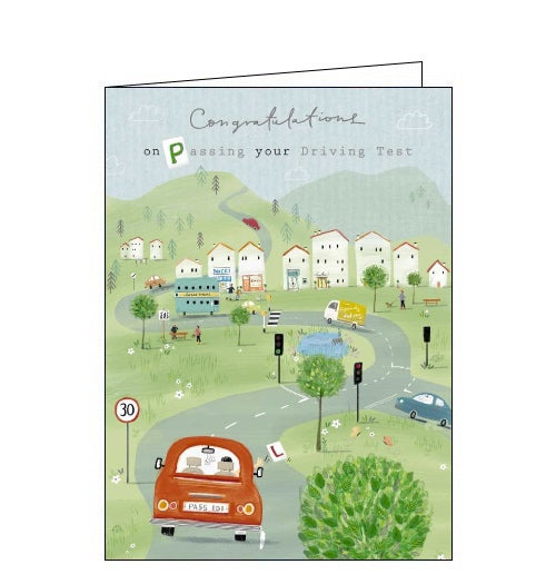 This congratulations card is decorated with a scene of a car driving into a town, throwing the 'L' plates out of the car window. The text on the front of the card reads 