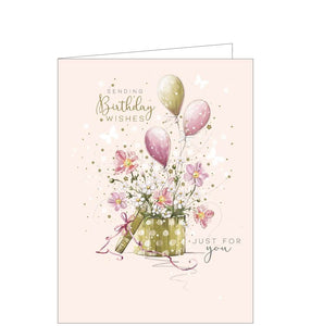 This beautiful birthday card features an illustration by Franny Lee of a hat box filled with flowers and balloons. Gold text on the front of the card reads "Sending Birthday wishes".
