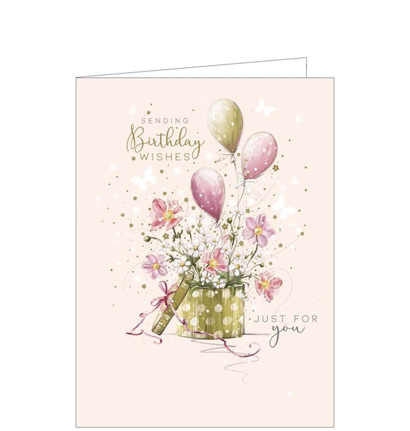 This beautiful birthday card features an illustration by Franny Lee of a hat box filled with flowers and balloons. Gold text on the front of the card reads 
