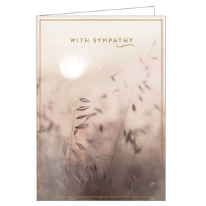This sympathy card is decorated with a sepia-toned photograph of a meadow scene. Gold text on the card reads "With sympathy".