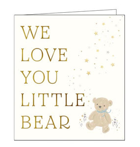 This very cute new baby card card is decorated with a tiny teddy bear wearing a blue ribbon, sitting on the ground surrounded by flowers and falling stars. Gold text on the front of the card reads "We love you little bear".