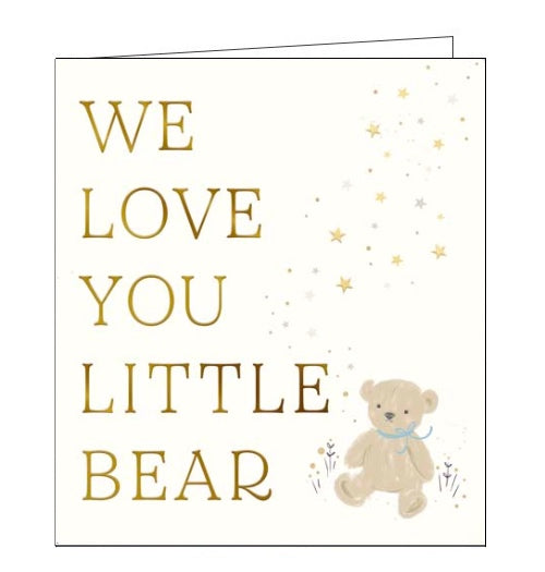 This very cute new baby card card is decorated with a tiny teddy bear wearing a blue ribbon, sitting on the ground surrounded by flowers and falling stars. Gold text on the front of the card reads 