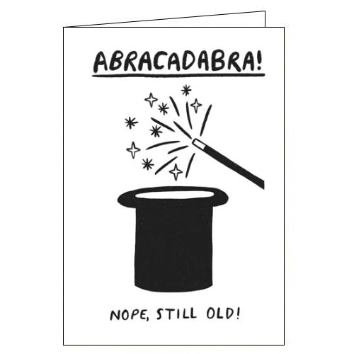 This funny birthday card is decorated with a black and white drawing of a magic wand being waved over a top hat. The caption on the front of the card reads 