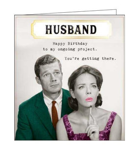 This funny birthday card for a special husband is decorated with a colourised vintage photograph of a man and woman looking off into the distance. The caption on the front of the card reads "Husband, Happy Birthday to my ongoing project....You're getting there".