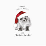 This Christmas card from Pigment Production's Life in Pencil card range is decorated with a black and white sketch of baby hedgehog, wearing a santa hat. The caption on the front of the card reads "Sending hogs & kisses and Christmas Wishes".
