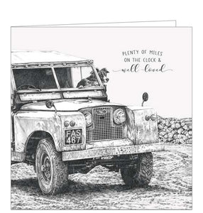 This sweet greetings card from Pigment Production's Life in Pencil card range is decorated with a black and white sketch of a border collie dog peeking out of the window of a vintage 4x4 car. The caption on the front of the card reads "Plenty of miles on the clock & well loved".
