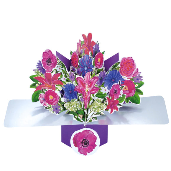 Pop-up 3D keepsake card shaped like a beautiful bouquet glittery of pink lilies, purple and blue flowers. The card has a flower shaped tag in addition to a blank panel on the back for your own message.