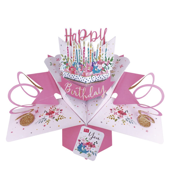 This pink pop-up 3D keepsake card is decorated with a pink birthday cake topped with glittery cake candles and flowers. Text on the card reads 