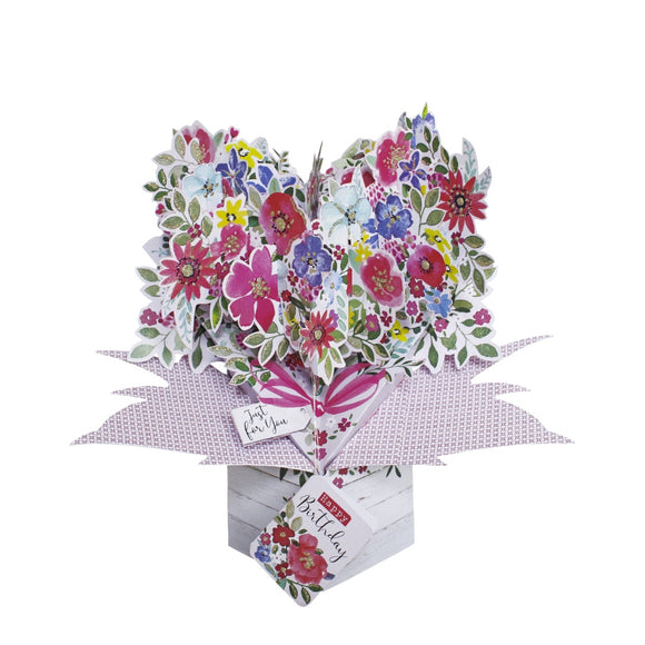 This beautiful pop-up birthday card opens up to reveal a 3d heart of pink and purple glittery flowers. Text on the front of the card reads 