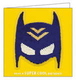 A card and a birthday gift in one! This birthday card features a superhero mask sequin patch that can be removed and added to bags, jackets and more. Text on the front of the card reads "Have a SUPER COOL Birthday!"