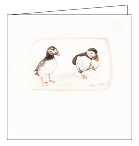 This blank greetings card from Woodmansterne's Habitat range that raises funds for the National Trust, features a beautiful illustration by Amy Eastland showing two puffins - one standing on one webbed foot, the other watching.