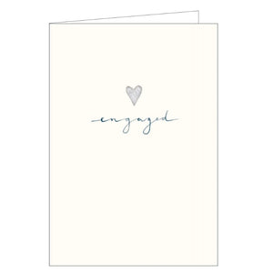 This simple and elegant engagement card is decorated with a tiny silver heart and blue script that reads "engaged".