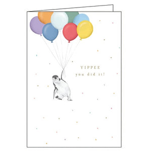 This congratulations card is decorated with a cute illustration of a penguin being lifted into the air by a bunch of balloons. Gold text on the card reads "YIPPEE You did it!"