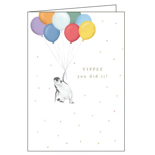 This congratulations card is decorated with a cute illustration of a penguin being lifted into the air by a bunch of balloons. Gold text on the card reads 