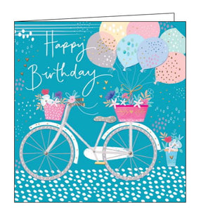 This lovely birthday card is decorated with vintage-style white and grey bike with pink front and back baskets overflowing with flowers. A bunch of pastel balloons have been tied to the back of the bicyle. White text on the front of the card reads "Happy Birthday"