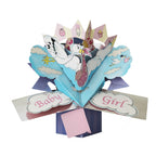 This 3D keepsake new baby girl card is decorated with a scene of a stork in a delivery hat carrying a baby in a pink blanket though the clouds. Text on the card reads "Baby Girl".